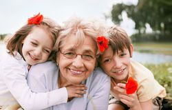 stock-photo-closeup-summer-portrait-of-happy-grandmother-with-grandchildren-outdoors-198757637